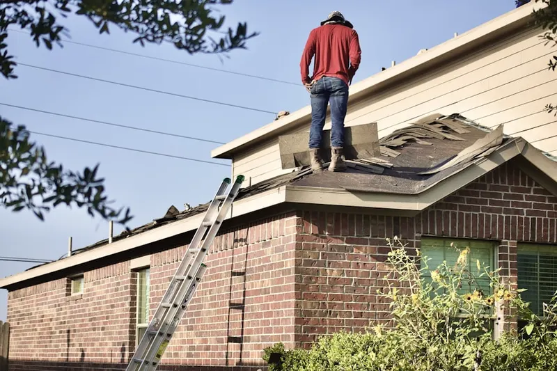 Professional roofer working on a residential roof in West Perrine